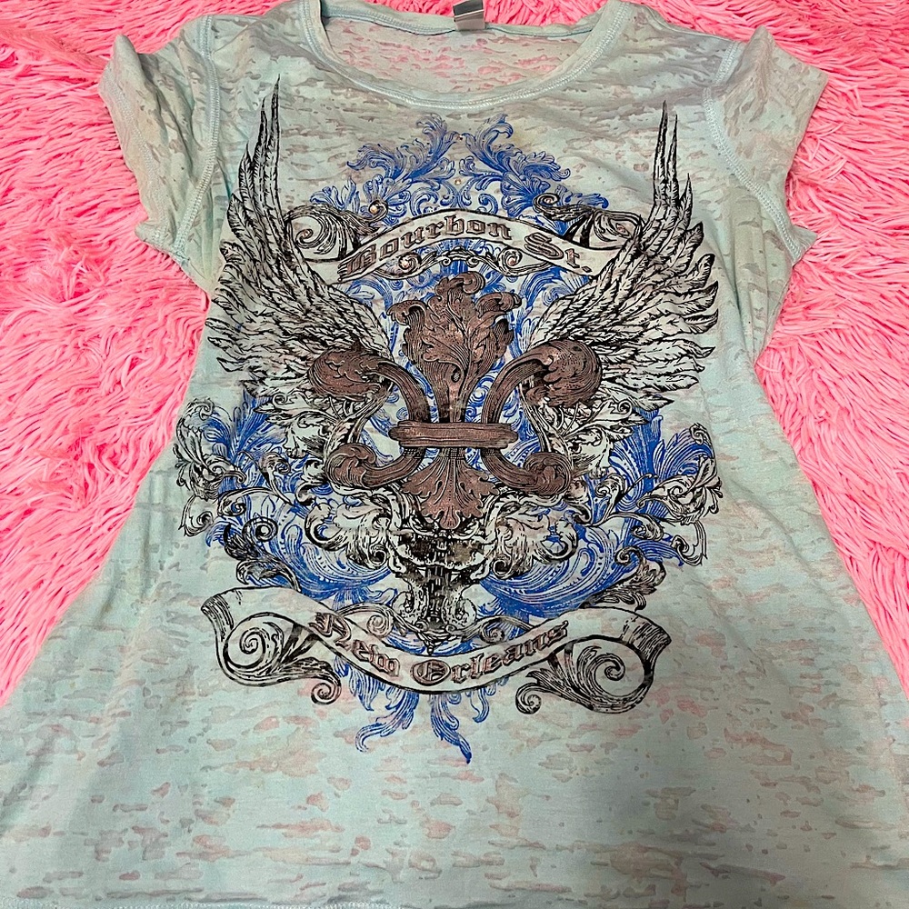 Light blue top, size medium 8/10, designs front and back.